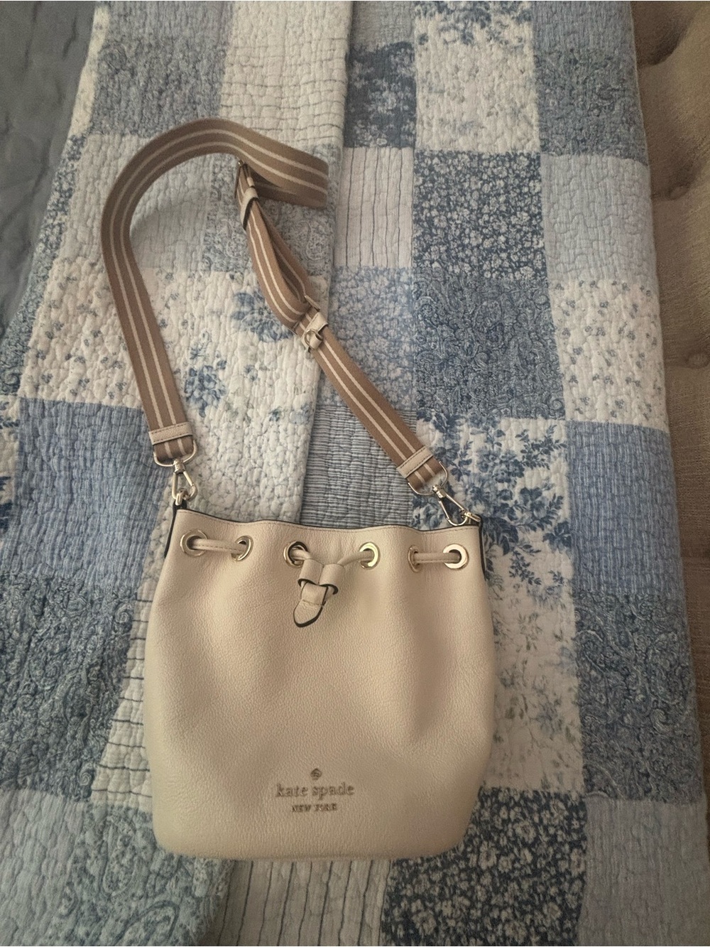 kate spade cream pebbled leather drawstring crossbody with striped strap